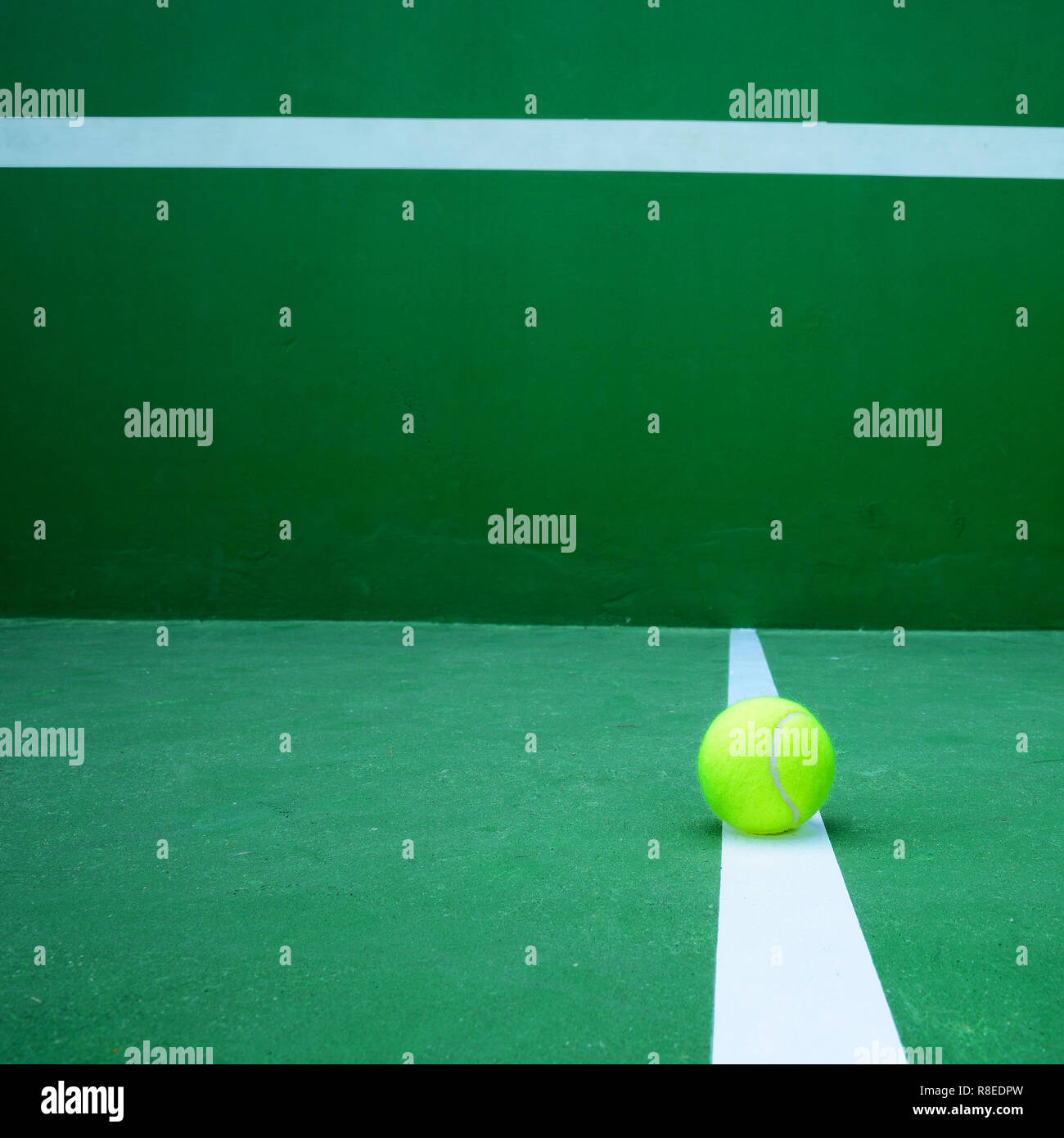 tennis ball on green court Stock Photo Alamy
