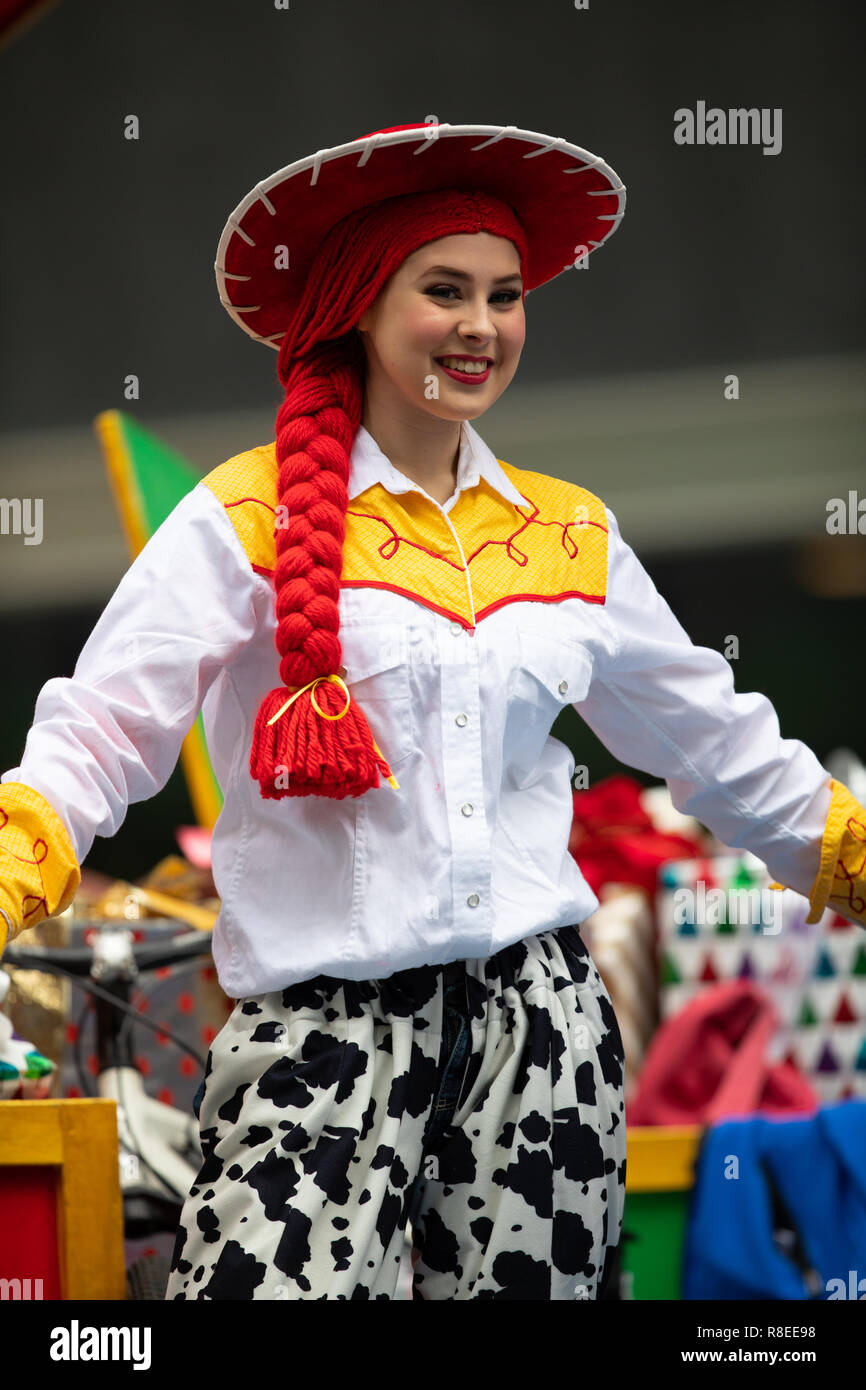 Houston, Texas, USA - November 22, 2018 The H-E-B Thanksgiving Day Parade, Woman on a float waving at people dress up as Jessie Toy Story Character Stock Photo