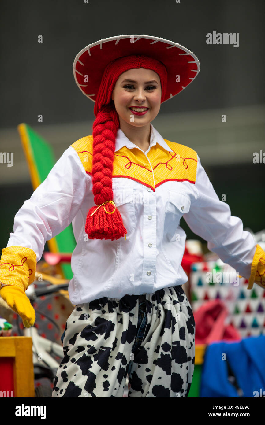 Houston, Texas, USA - November 22, 2018 The H-E-B Thanksgiving Day Parade, Woman on a float waving at people dress up as Jessie Toy Story Character Stock Photo