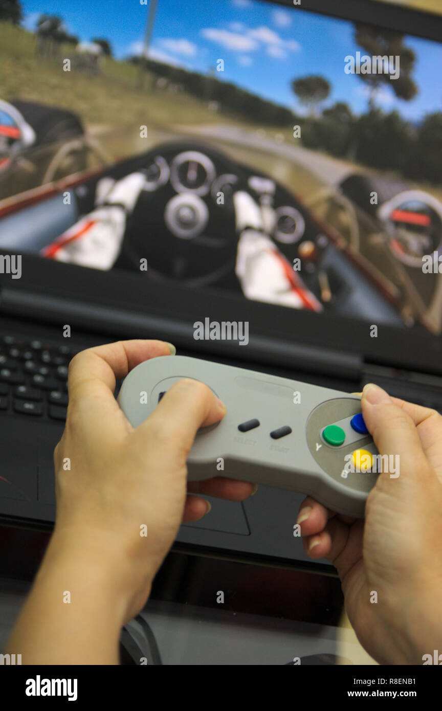 Premium Photo  Close up of gamer holding controller to play video games in  front of computer. player using joystick and playing online games on  monitor, sitting at desk. man gaming with