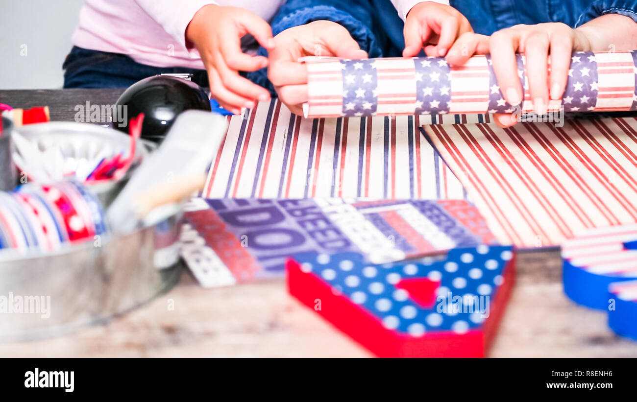 Step by step. Mother and daughter making paper firecrackers for July ...