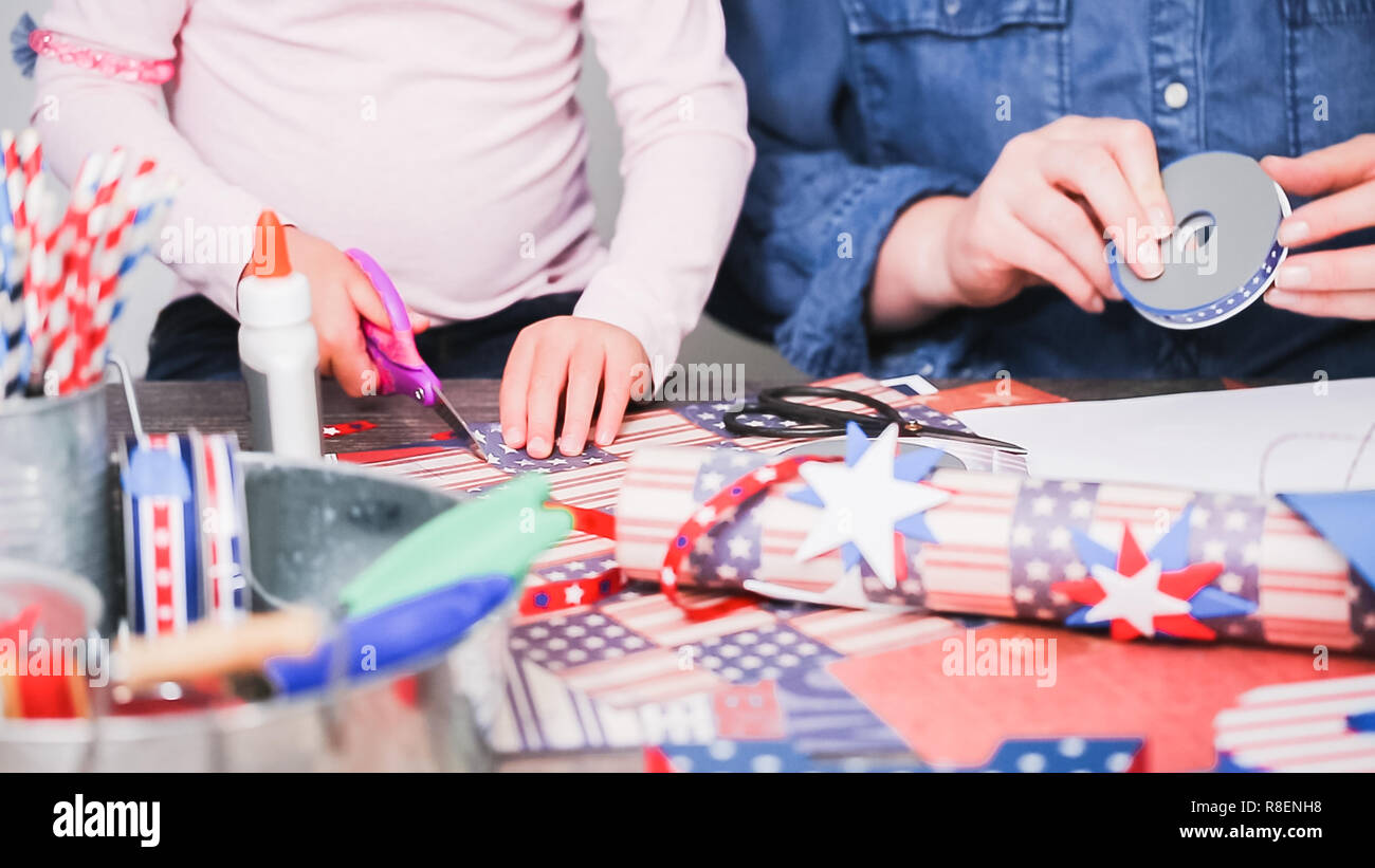 Step by step. Mother and daughter making paper firecrackers for July ...