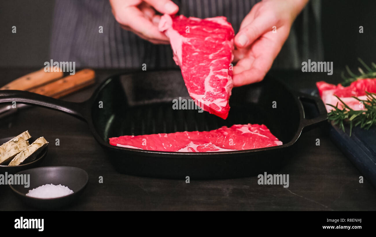 Raw New York strip steaks in cast iron frying pan Stock Photo Alamy