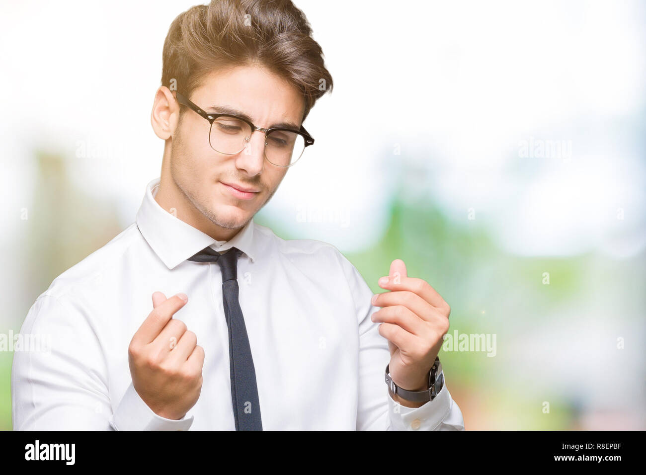 Young business man wearing glasses over isolated background Doing money  gesture with hand, asking for salary payment, millionaire business Stock  Photo - Alamy