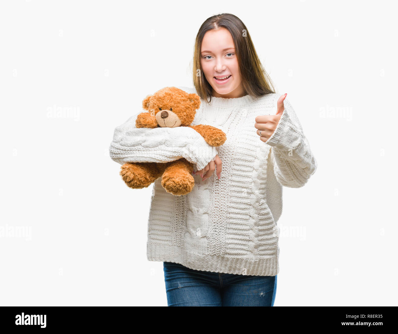 Young caucasian woman holding teddy bear over isolated background happy ...