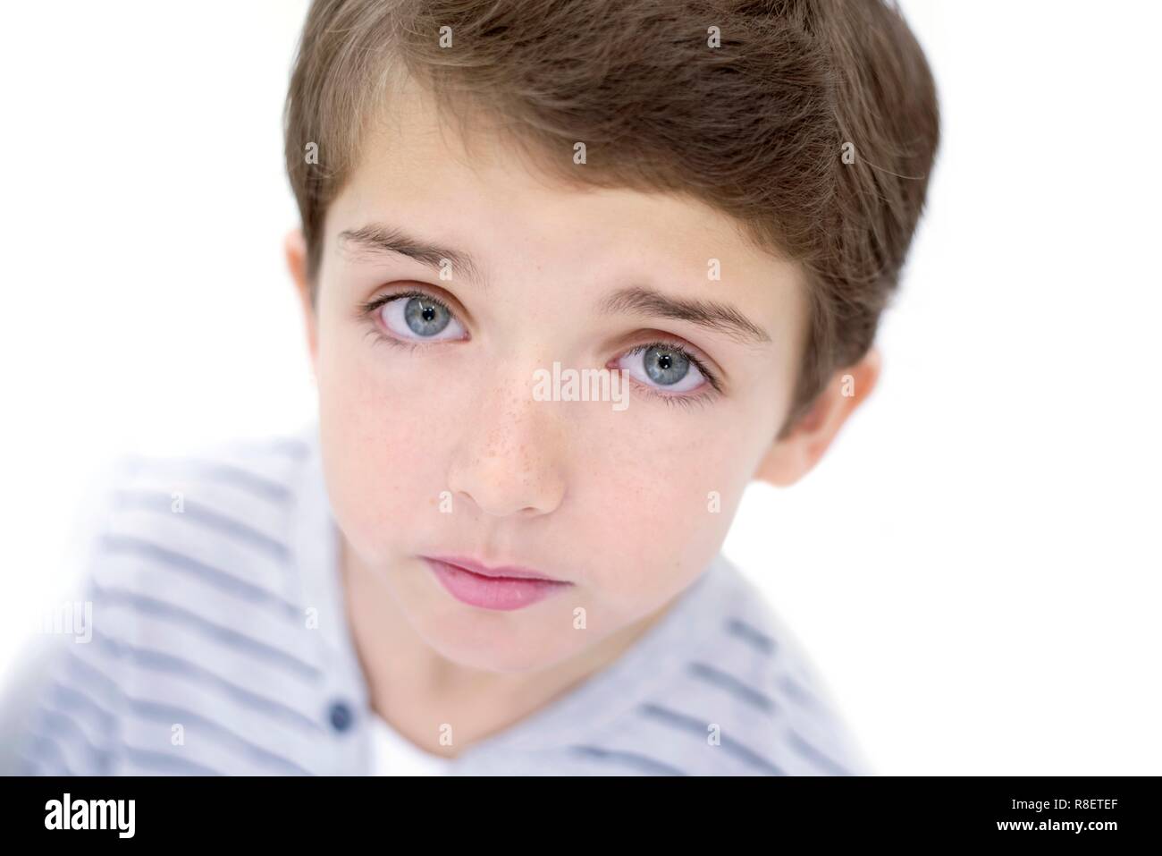 Young boy looking up toward camera, portrait. Stock Photo