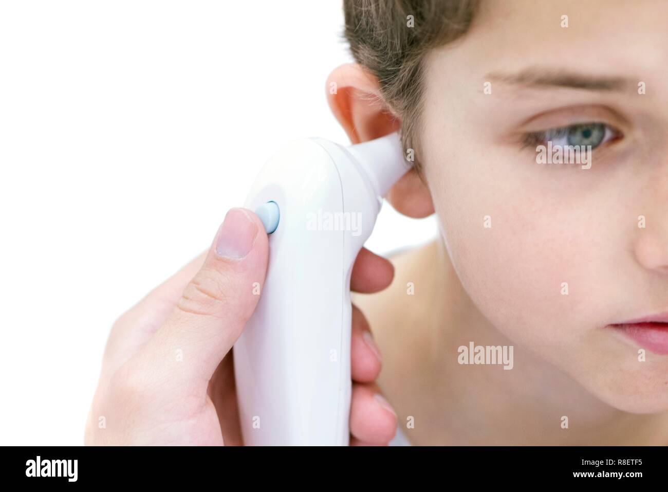 Boy having his temperature taken with a digital thermometer. Stock Photo