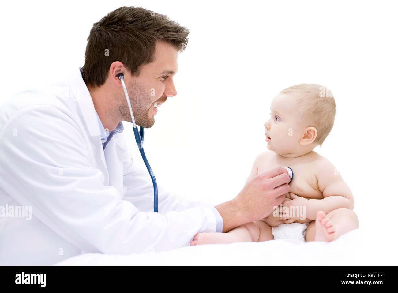 Doctor examining baby using stethoscope. Stock Photo