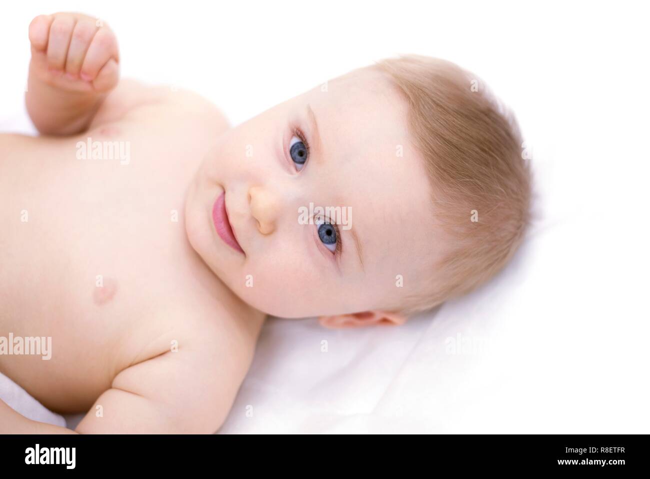 Baby lying down, portrait. Stock Photo