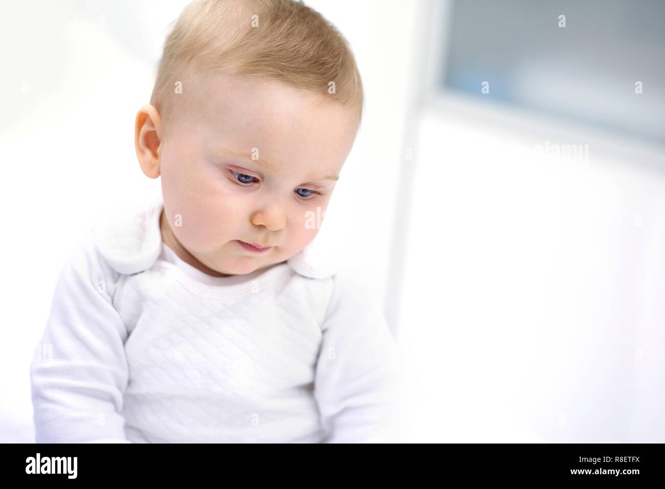 Baby boy looking down. Stock Photo