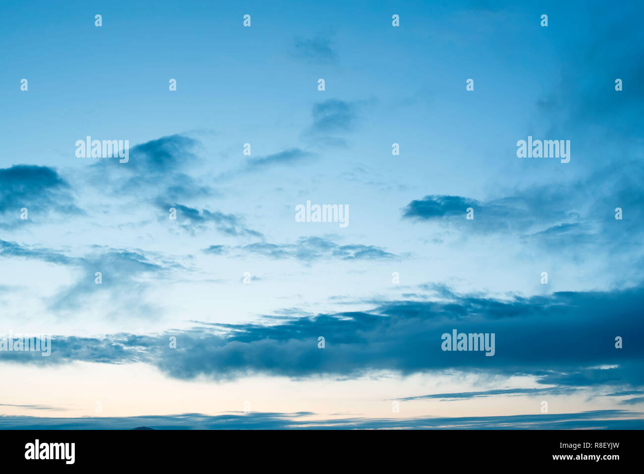 Cumulus clouds of the sunset with the sunset. Blue sky blurred background defocusing Stock Photo
