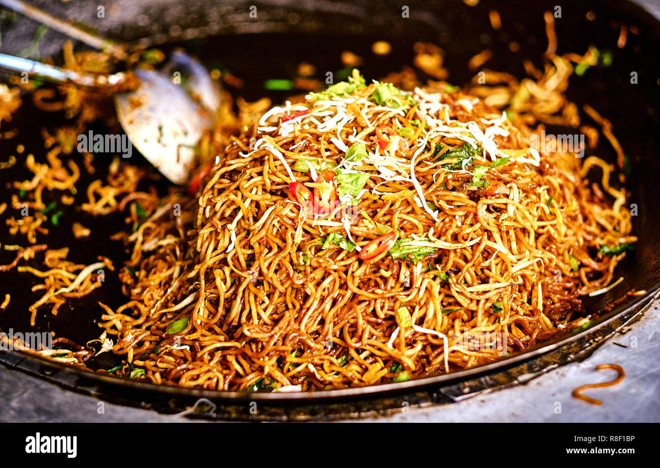 Fried noodles in a wok. Asian, Indian and Chinese street food. Food court  on local market of Langkawi island, Malaysia. Traditional asian street food  Stock Photo - Alamy