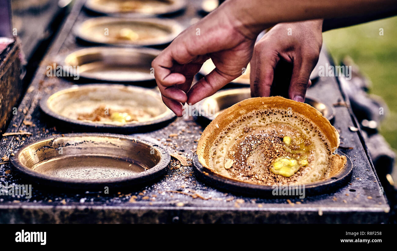 Cooking traditional asian pancakes. Indian and Chinese street food