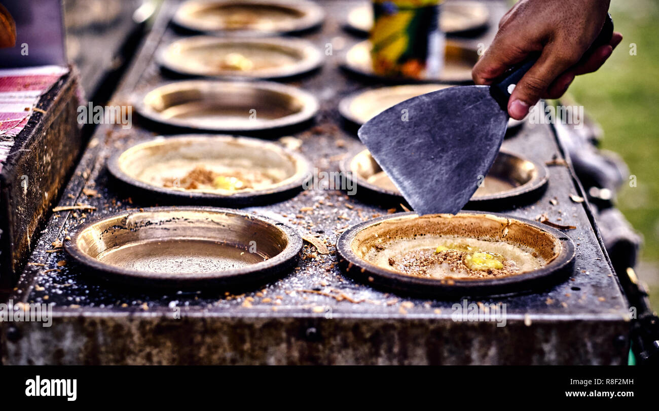 Cooking traditional asian pancakes. Indian and Chinese street food