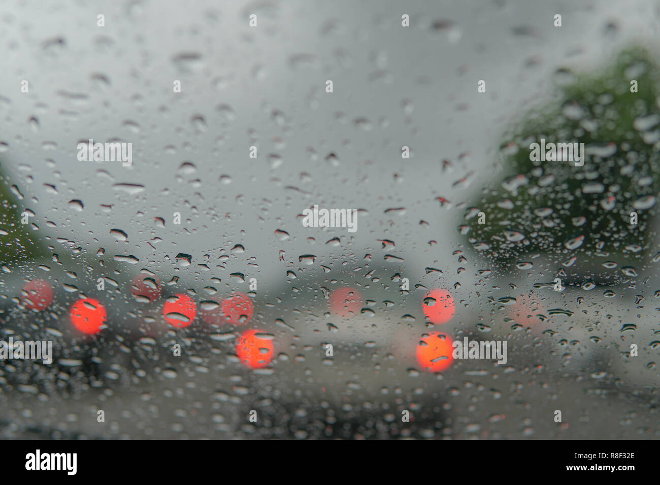 rain droplets on car windshield, traffic in city Stock Photo - Alamy