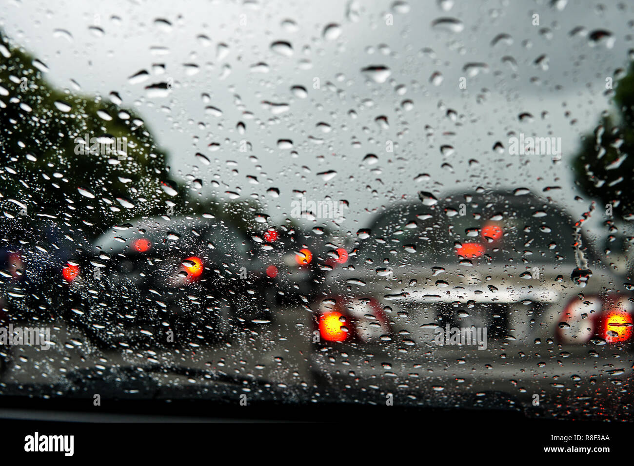 Rain drop on the car glass background.Road view through car window with