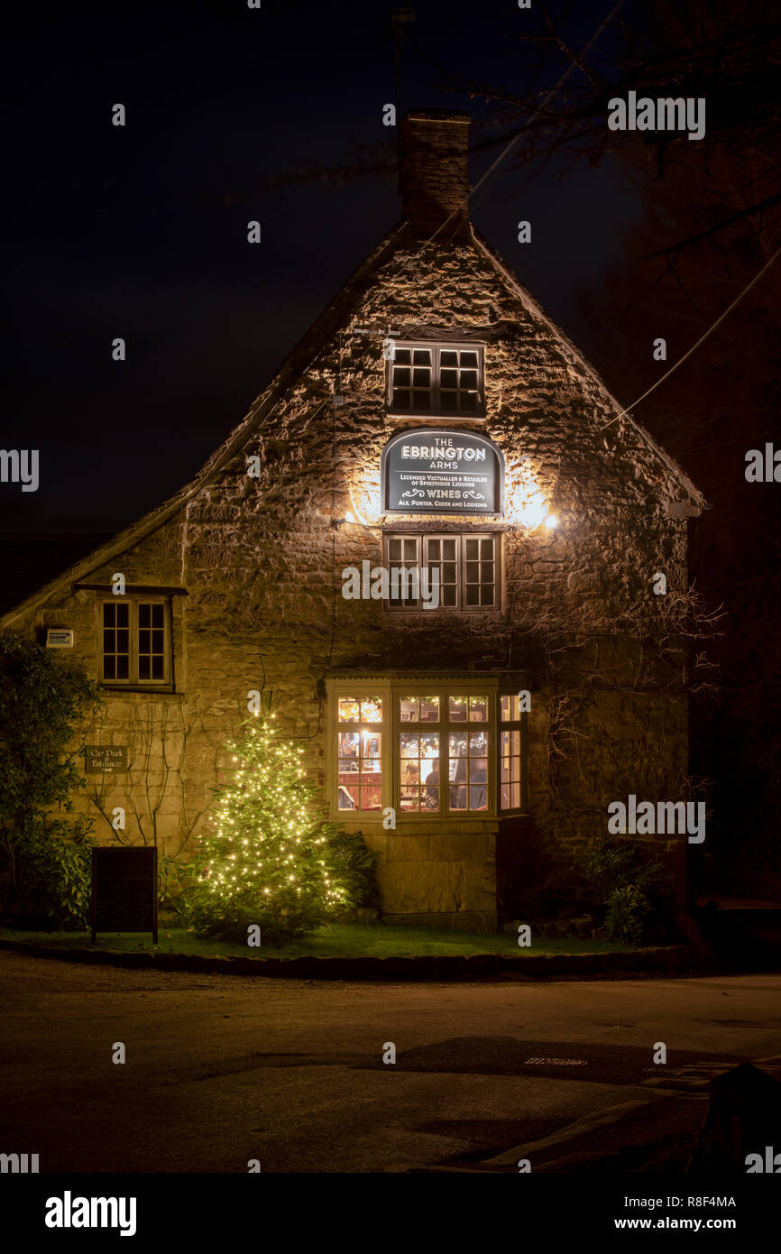 Christmas tree outside The Ebrington Arms at night. Ebrington, Chipping Campden, Gloucestershire, England Stock Photo