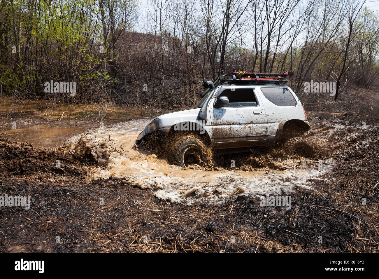 Suzuki Jimny crossing water obstacle or a swamp Stock Photo