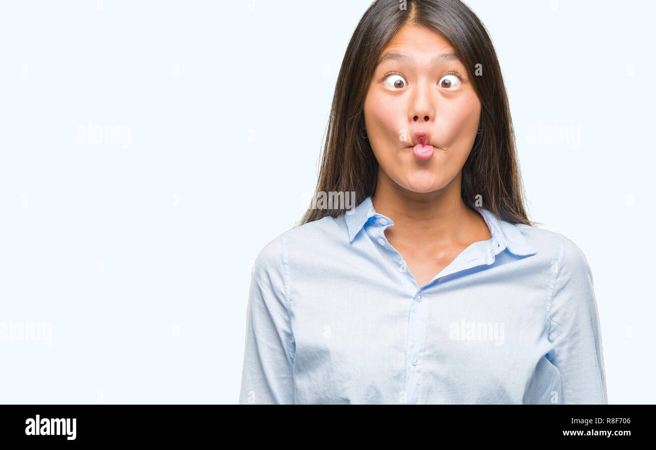 Young asian business woman over isolated background making fish