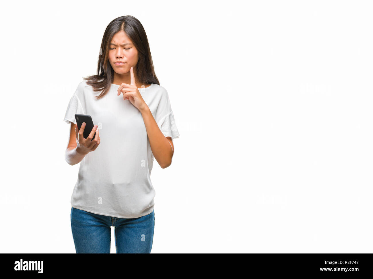 Young asian woman texting using smartphone over isolated background