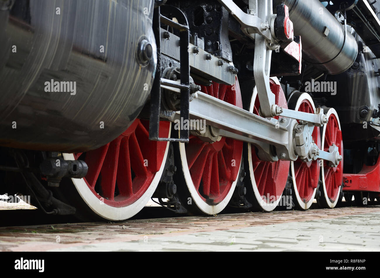 Red wheels of old USSR black steam locomotive. Wheels of an old soviet ...