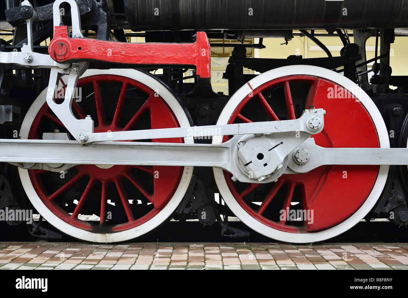 Red wheels of old USSR black steam locomotive. Wheels of an old soviet ...