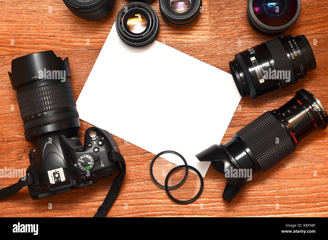 Complete kit for modern digital SLR camera and blank sheet of paper for ...