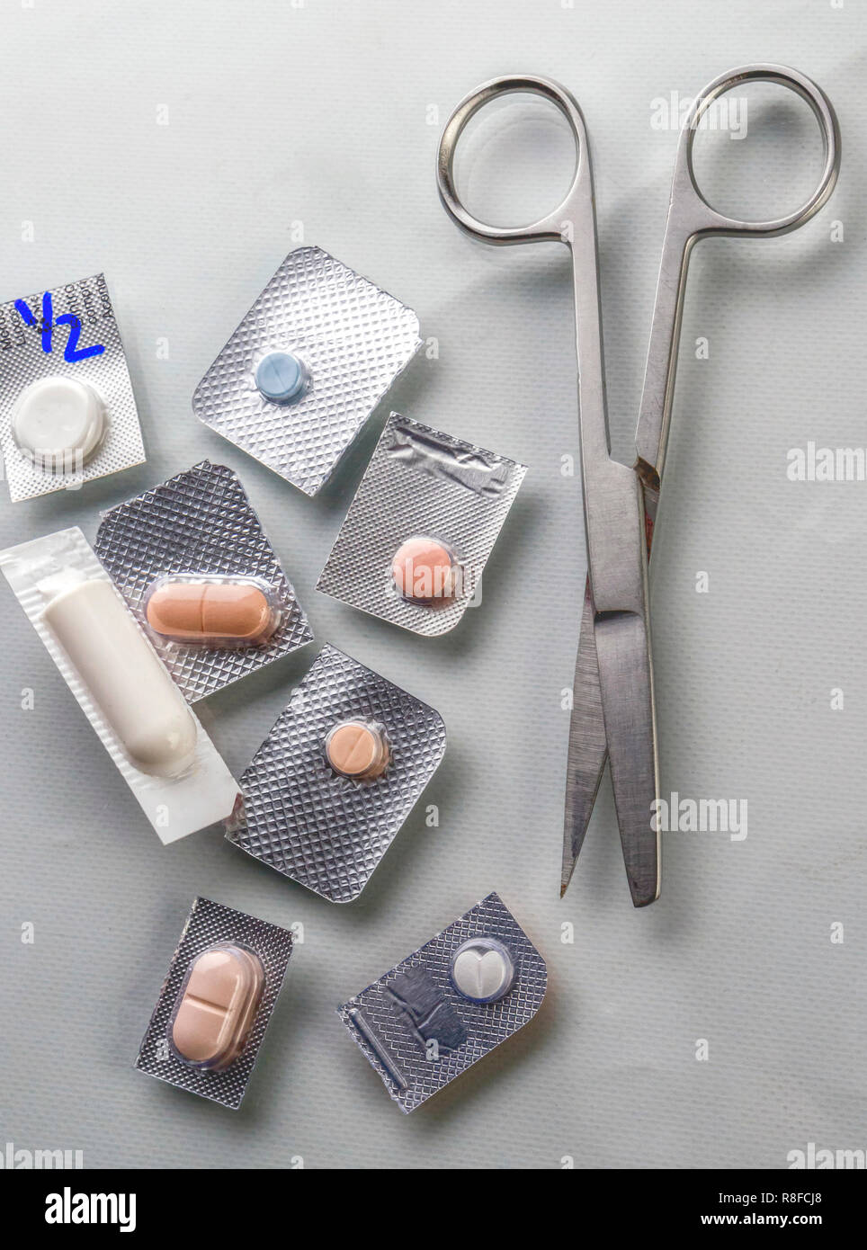 Different types of medications with scissors in a hospital, conceptual