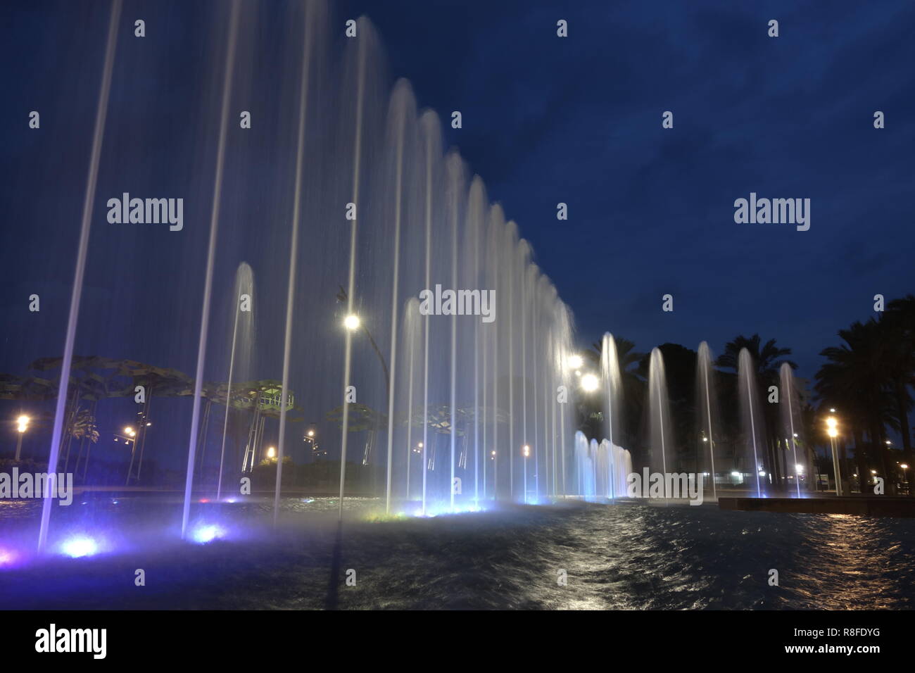 Fountain jets at night, in a long exposure shot Stock Photo