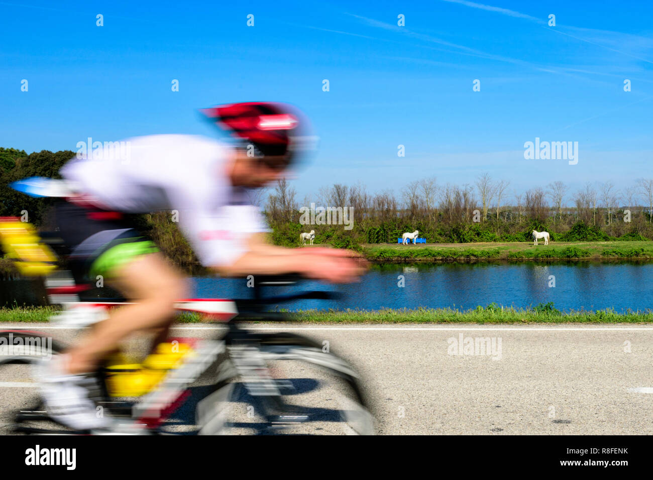 FERRARA, ITALIA - APRIL 14, 2018: Triathlon Irondelta at lido di Volano, an athlete during the bike fraction. Stock Photo