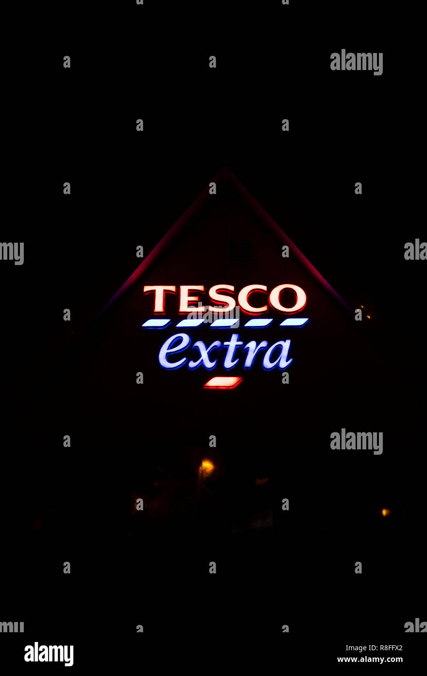 Tesco Extra supermarket neon sign over entrance, British multinational