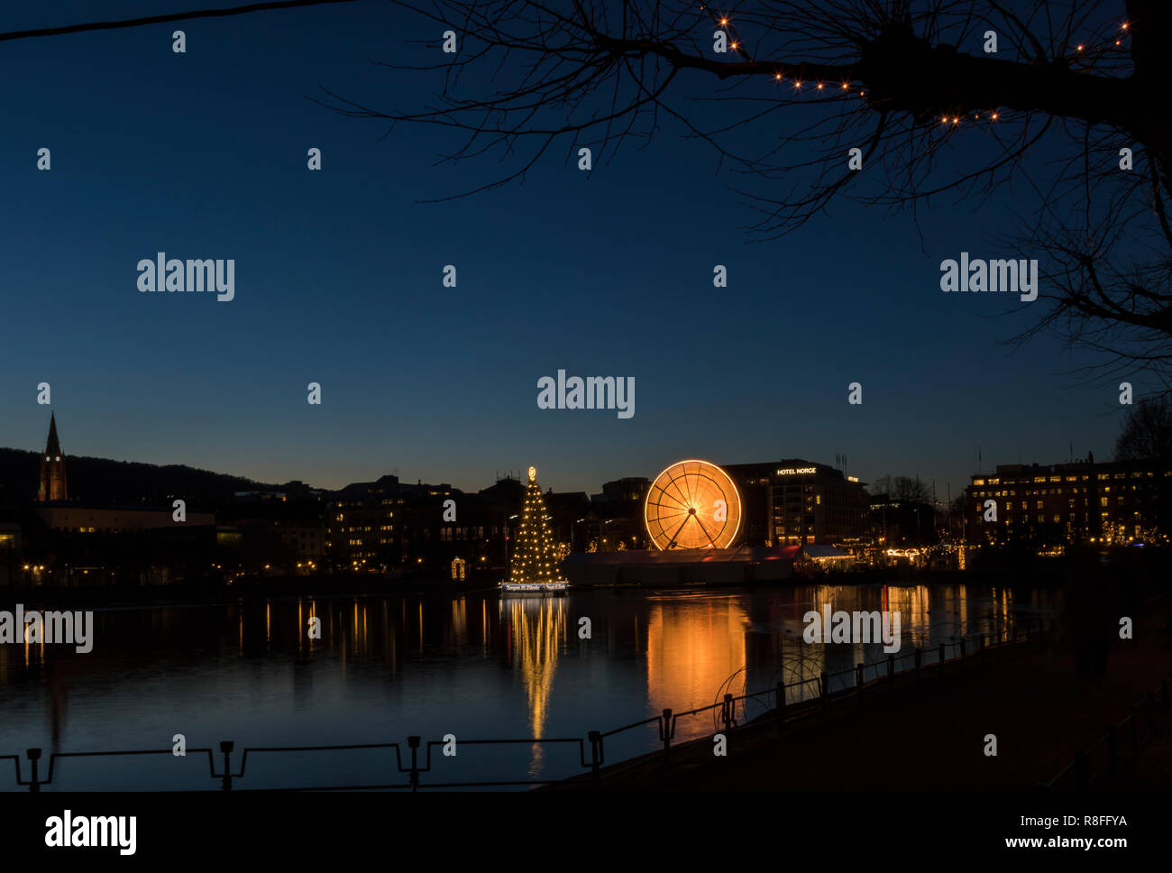 Christmas tree and Market by Lille Lungegaardsvannet Lake in downtown Bergen, Norway. Ferris wheel rotating. Stock Photo