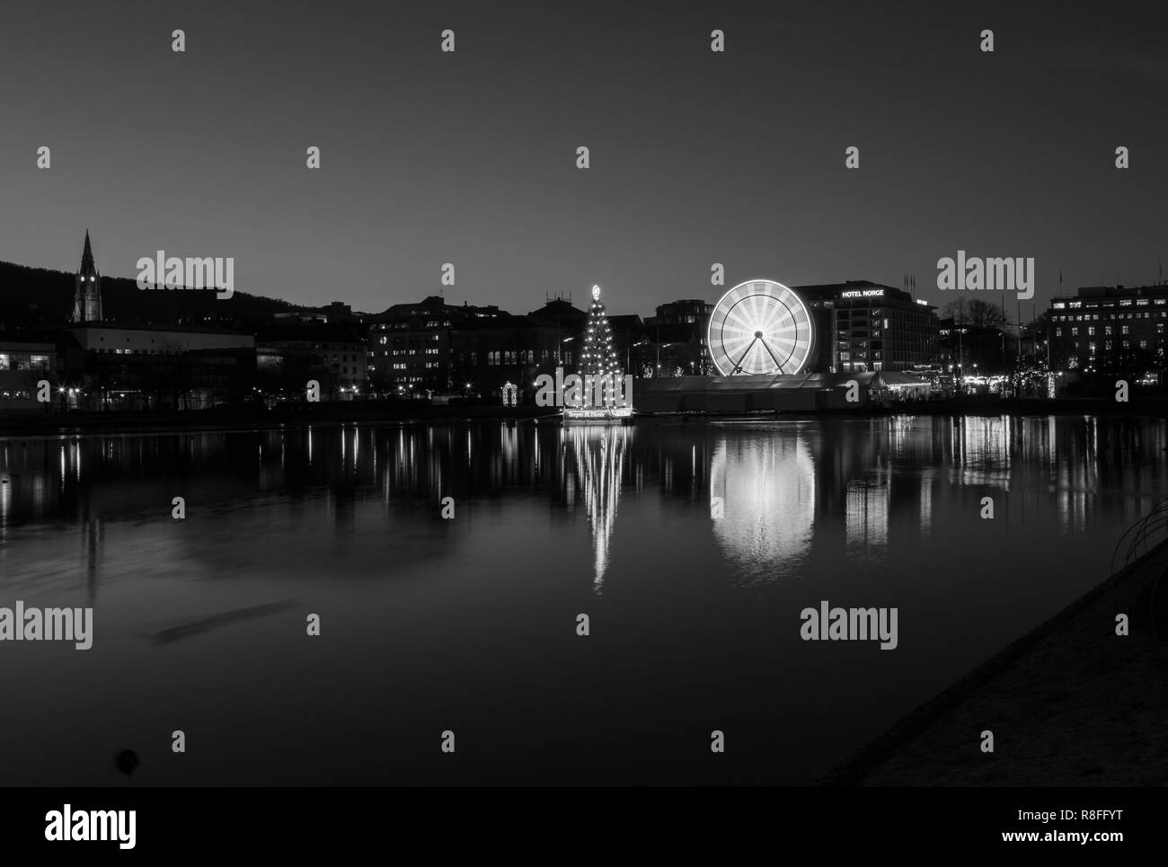 Christmas tree and Market by Lille Lungegaardsvannet Lake in downtown Bergen, Norway. Ferris wheel rotating. Stock Photo