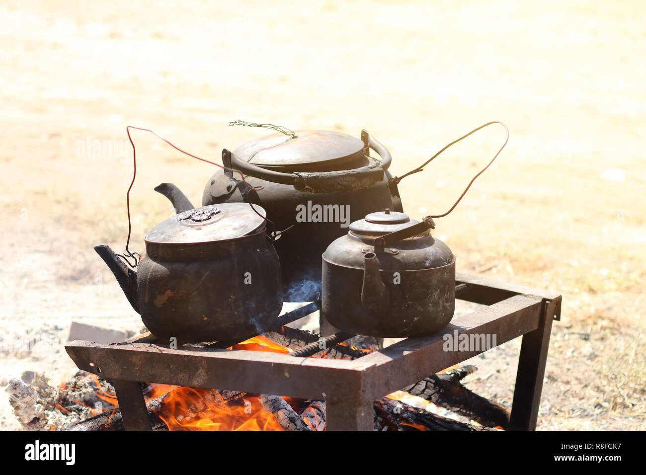 Cooking food in a rustic old kettle on bonfire in the forest Stock ...