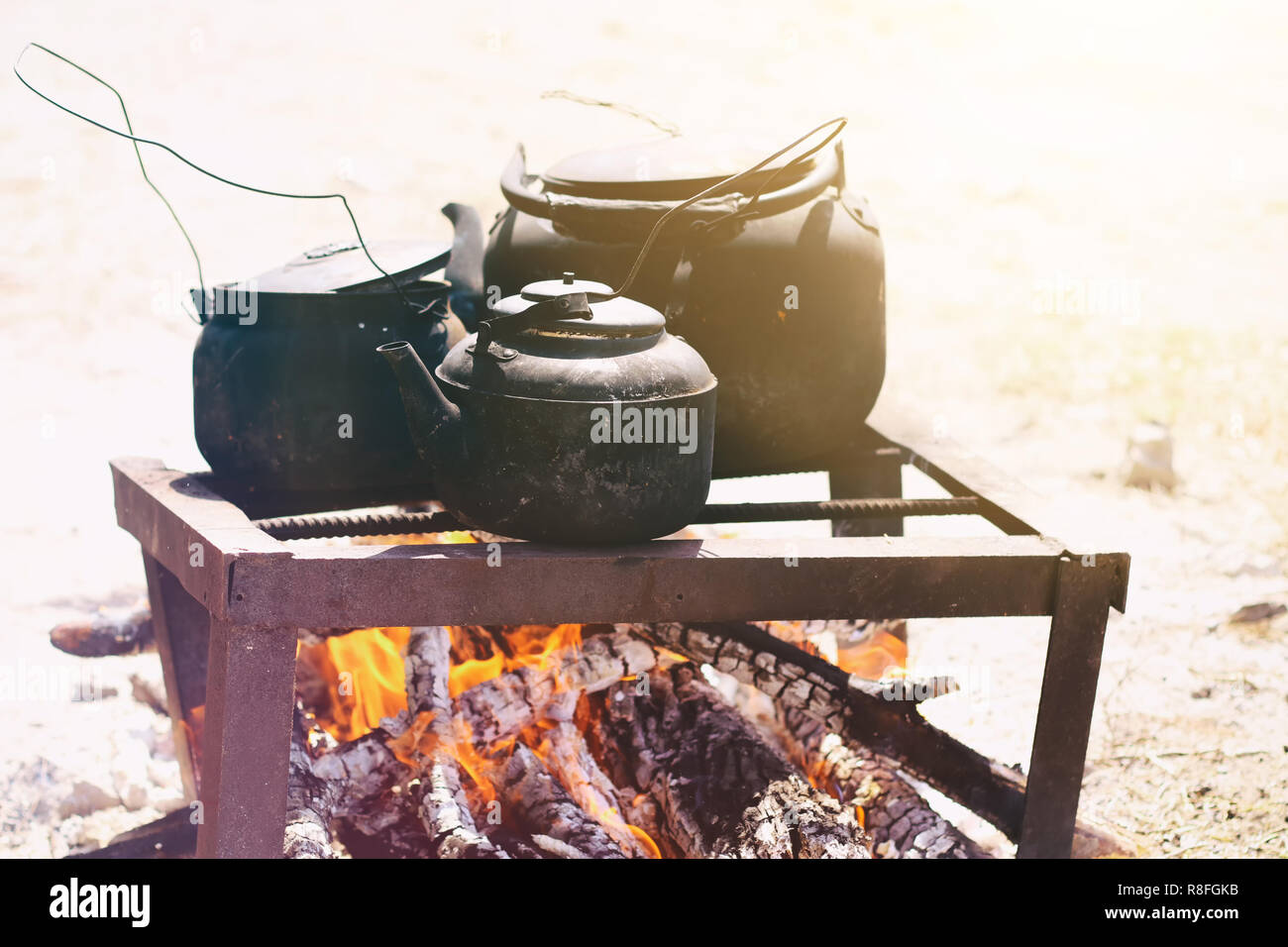 Cooking food in a rustic old kettle on bonfire in the forest Stock ...