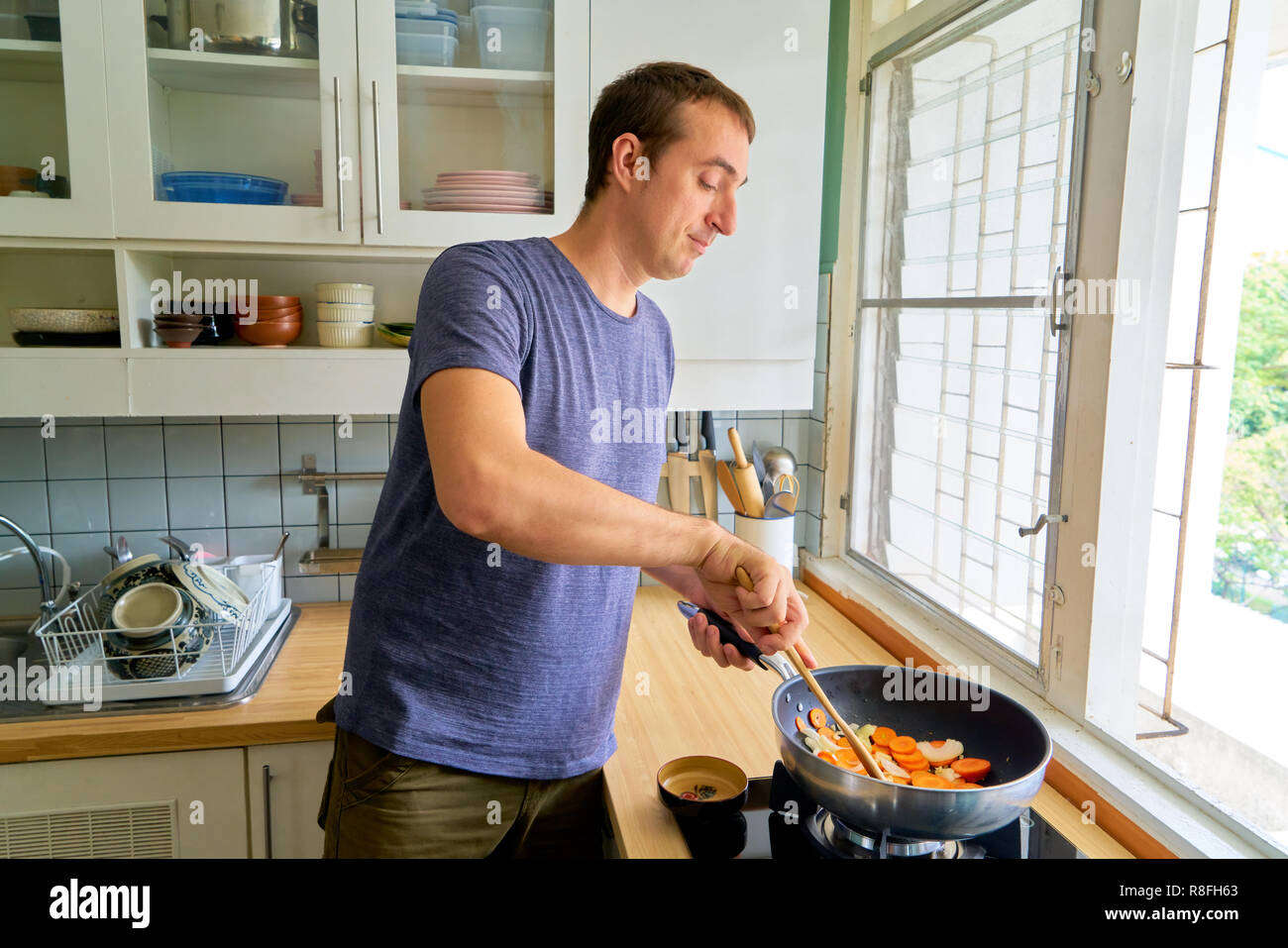 Handsome guy posing - cooking Stock Photo - Alamy