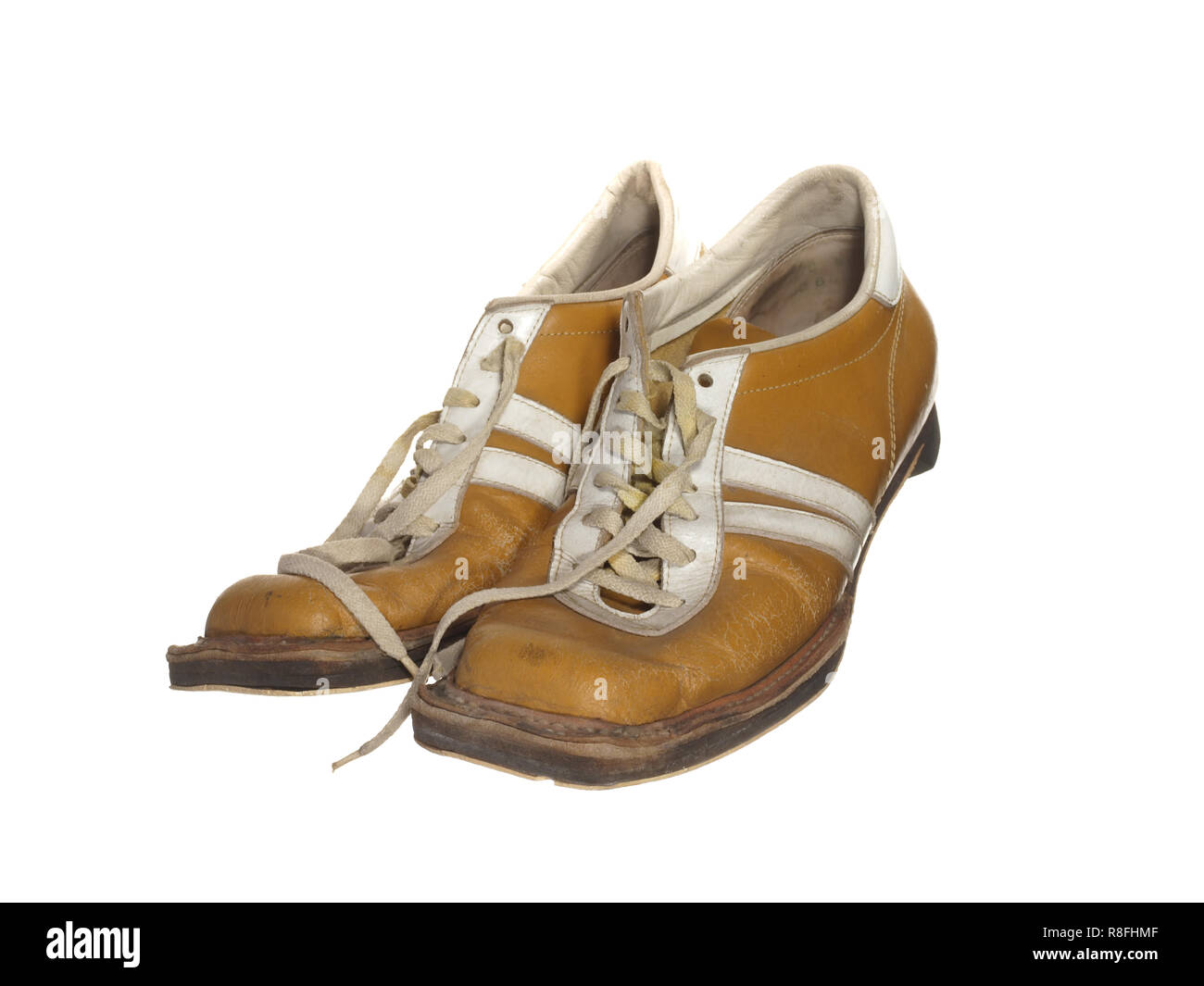 old ski boots of yellow color isolated on white background Stock Photo