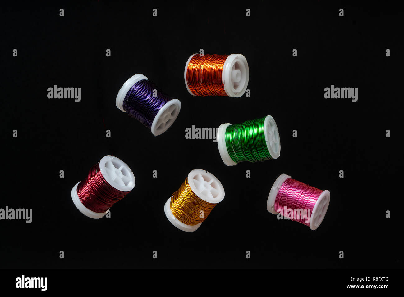 Some  spools of colored metallic thread Stock Photo