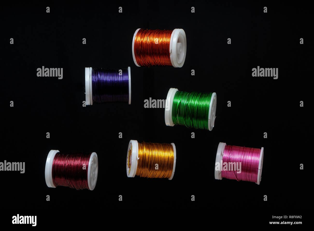 Some  spools of colored metallic thread Stock Photo