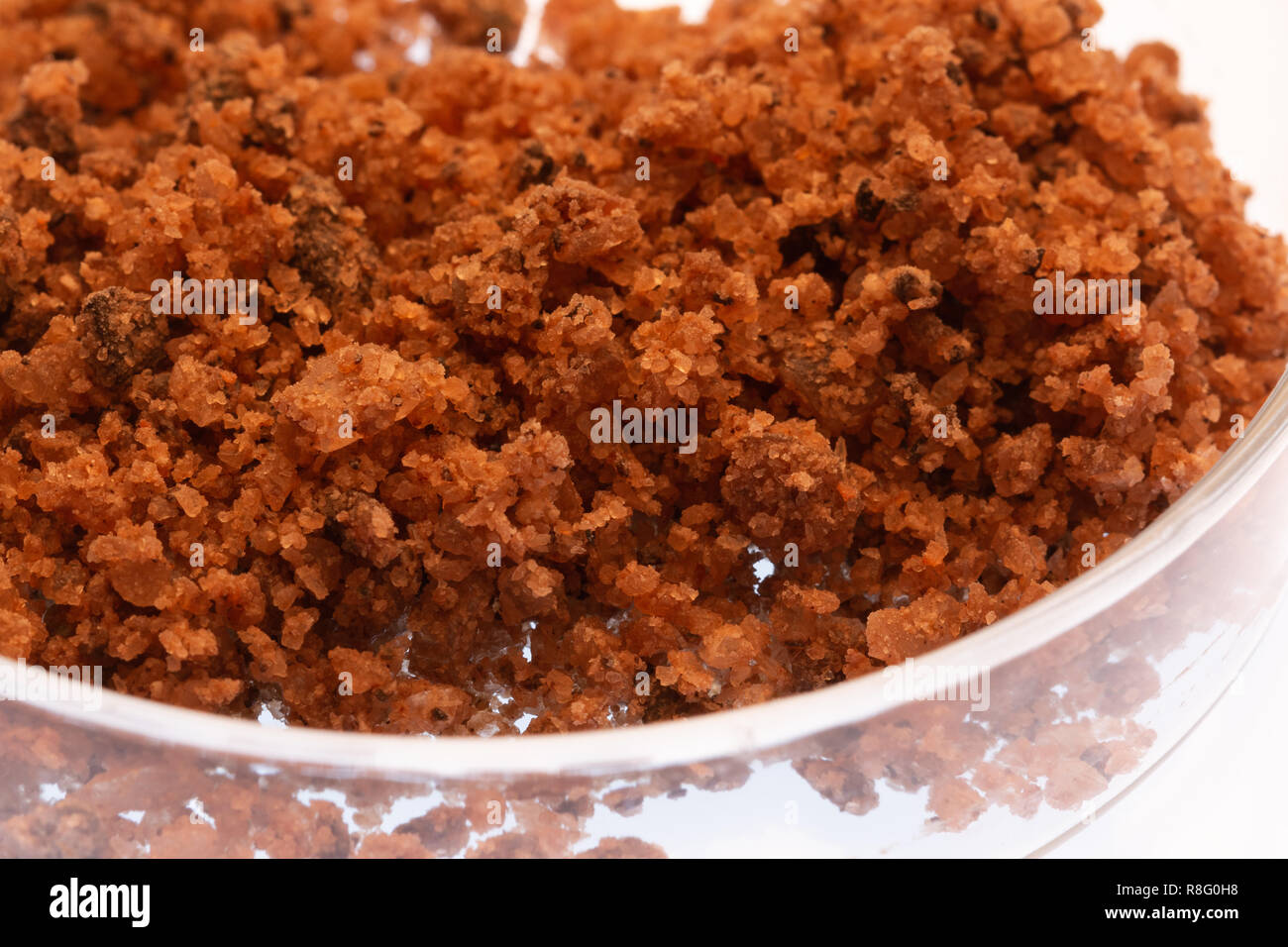 Close up of rock salt in a glass petri dish Stock Photo