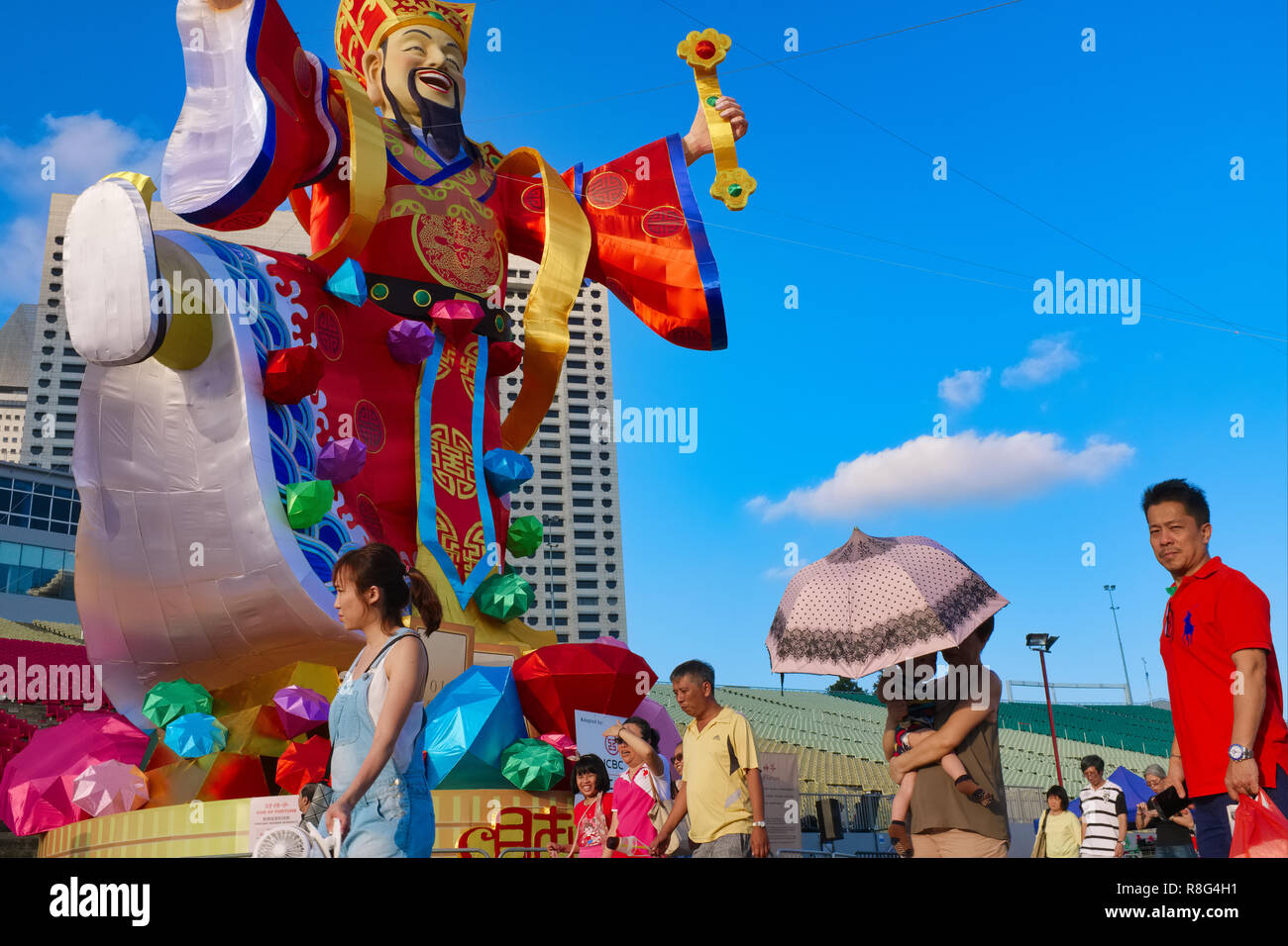 The cheerful figure of the Chinese god of good fortune, put up for Chinese New Year, by Marina Bay, Singapore Stock Photo