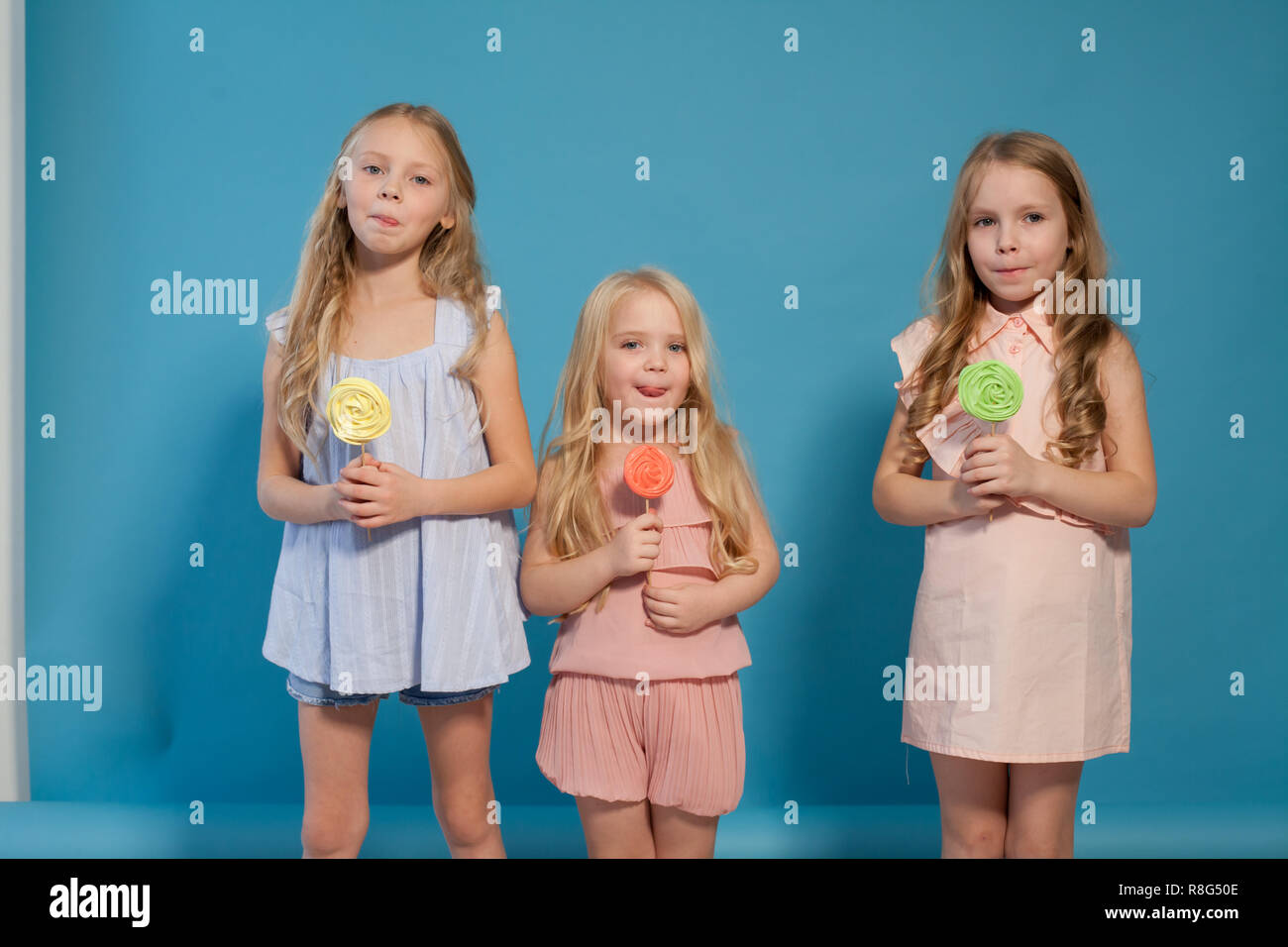 three girls girlfriend eat candy lollipop sister Stock Photo