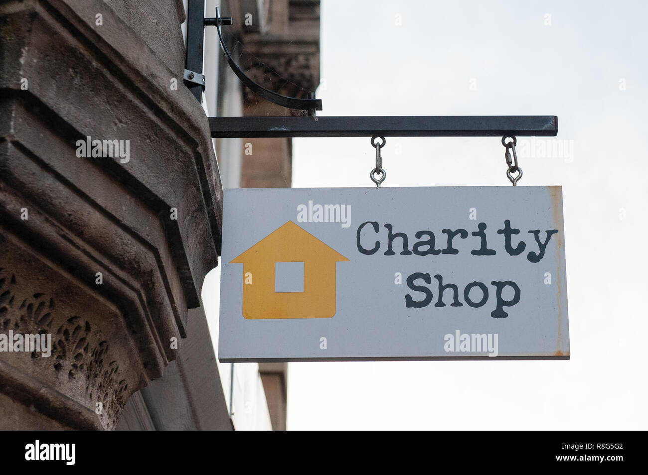 Hanging sign outside Charity Shop in Bradford on Avon, Wiltshire, UK. Stock Photo