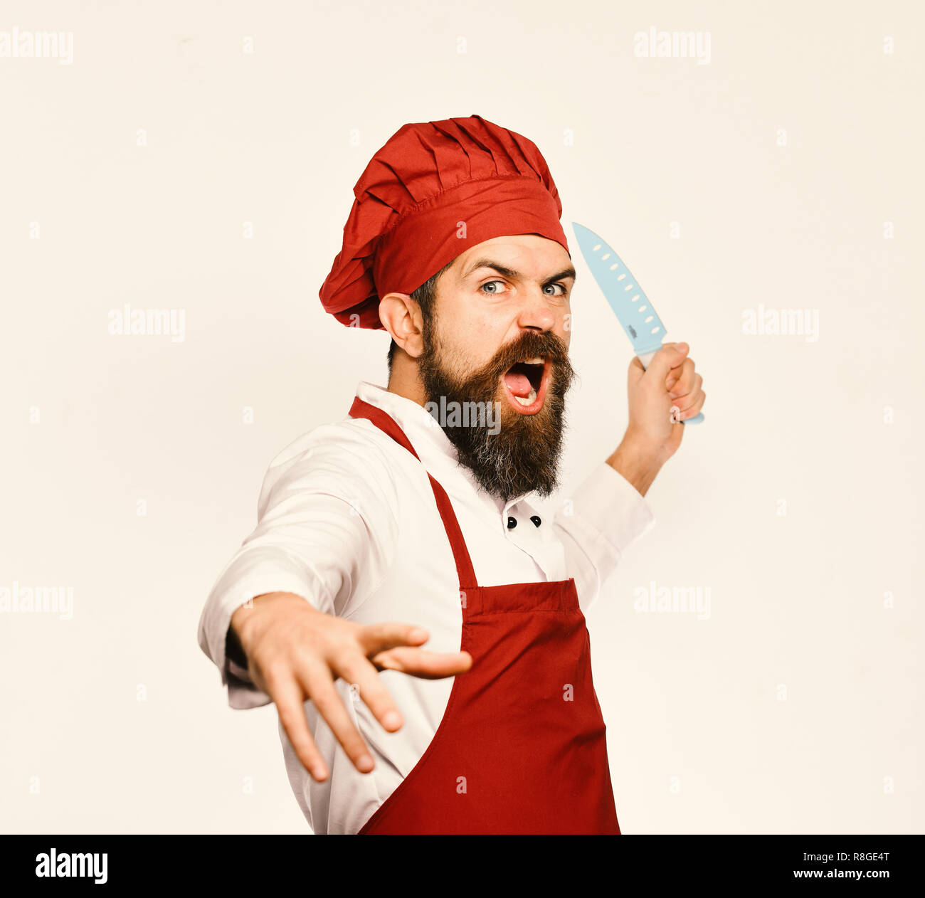 Cooking equipment and cuisine concept. Man with beard in cook uniform ...