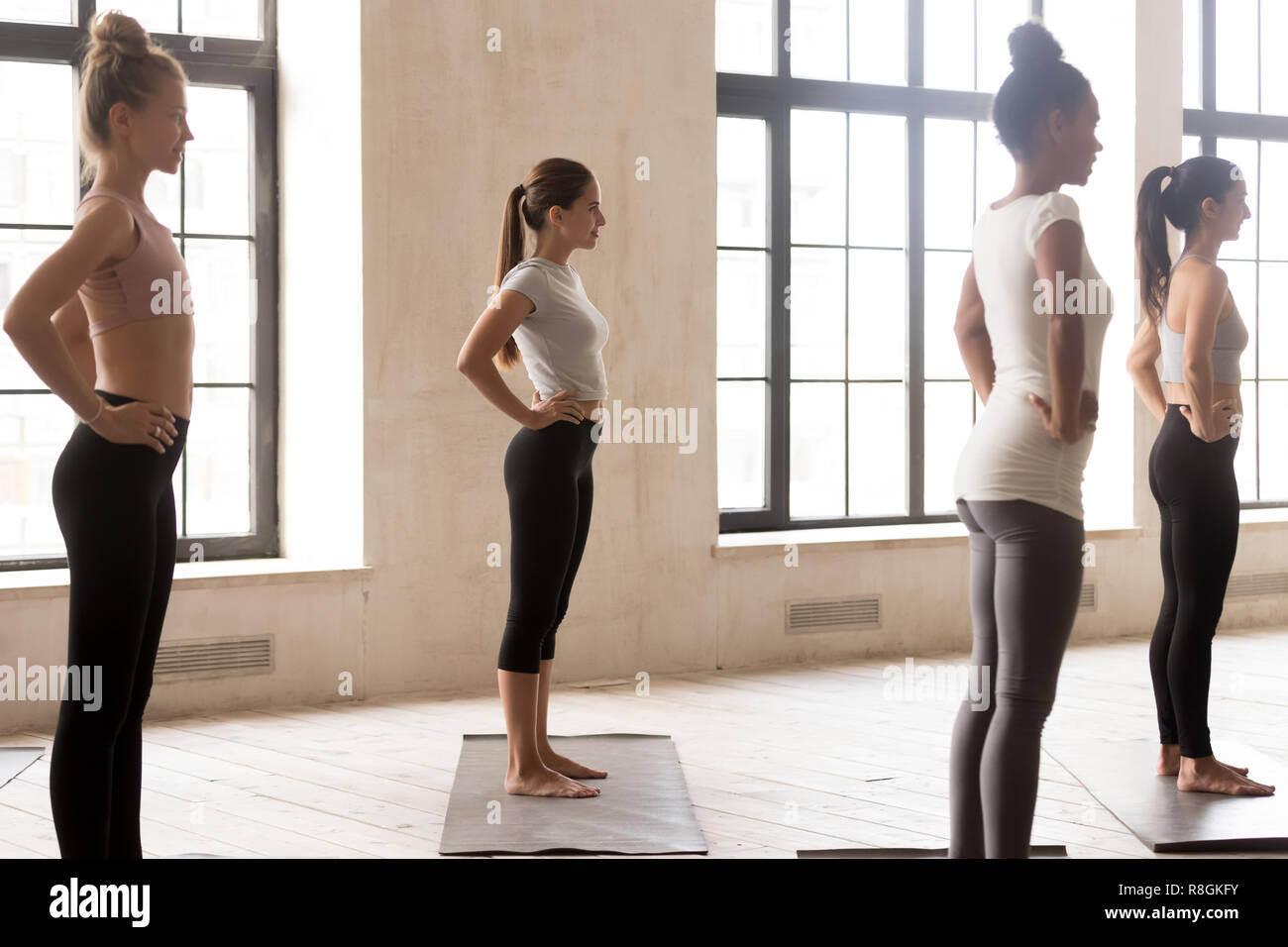 Four young multiracial girls ready for training, side view Stock Photo