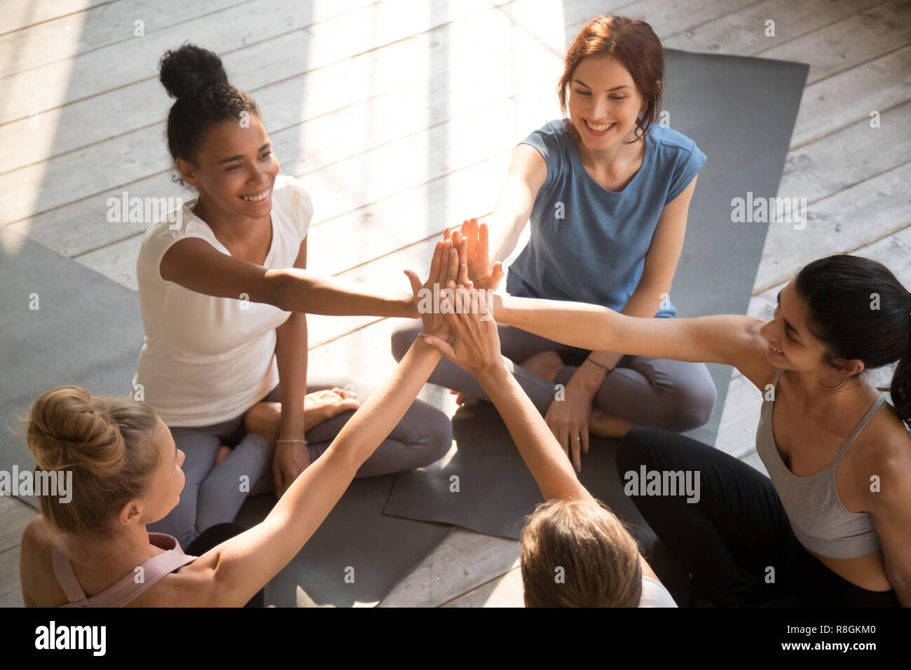 Females before start workout greeting each other giving high fiv Stock Photo