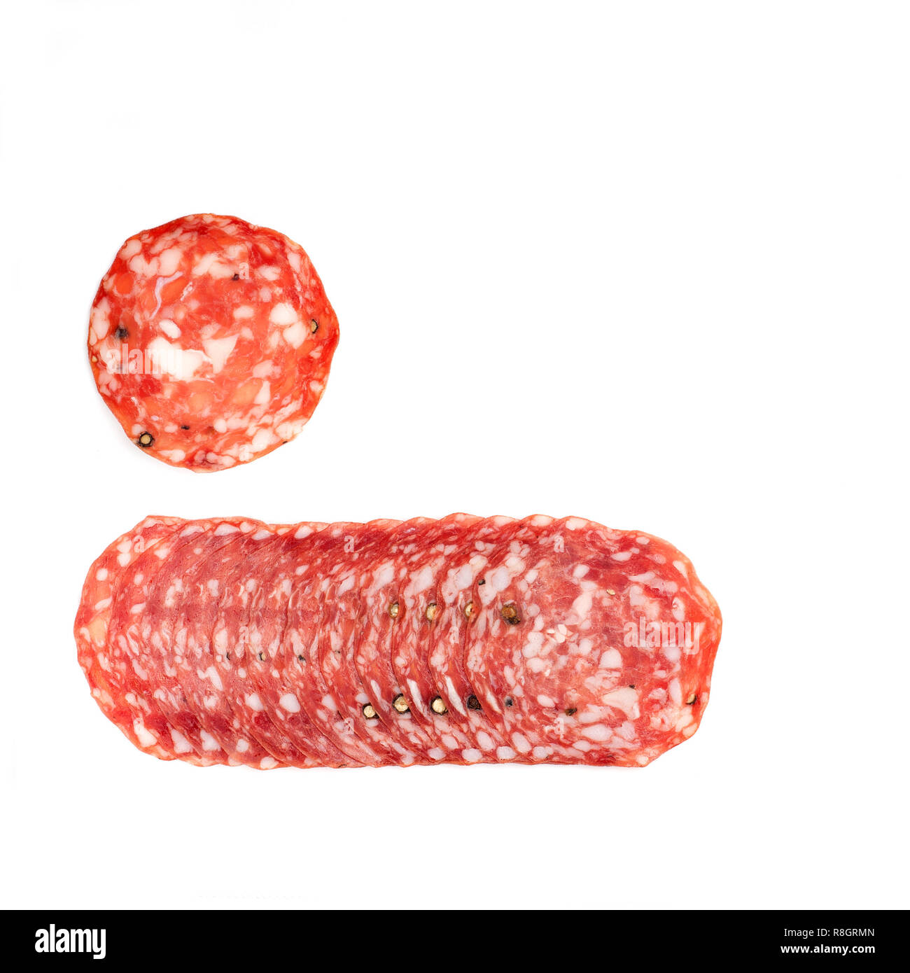 Spicy, dry, thin  sausage slices  isolated. Top view,  horizontal orientation. Stock Photo