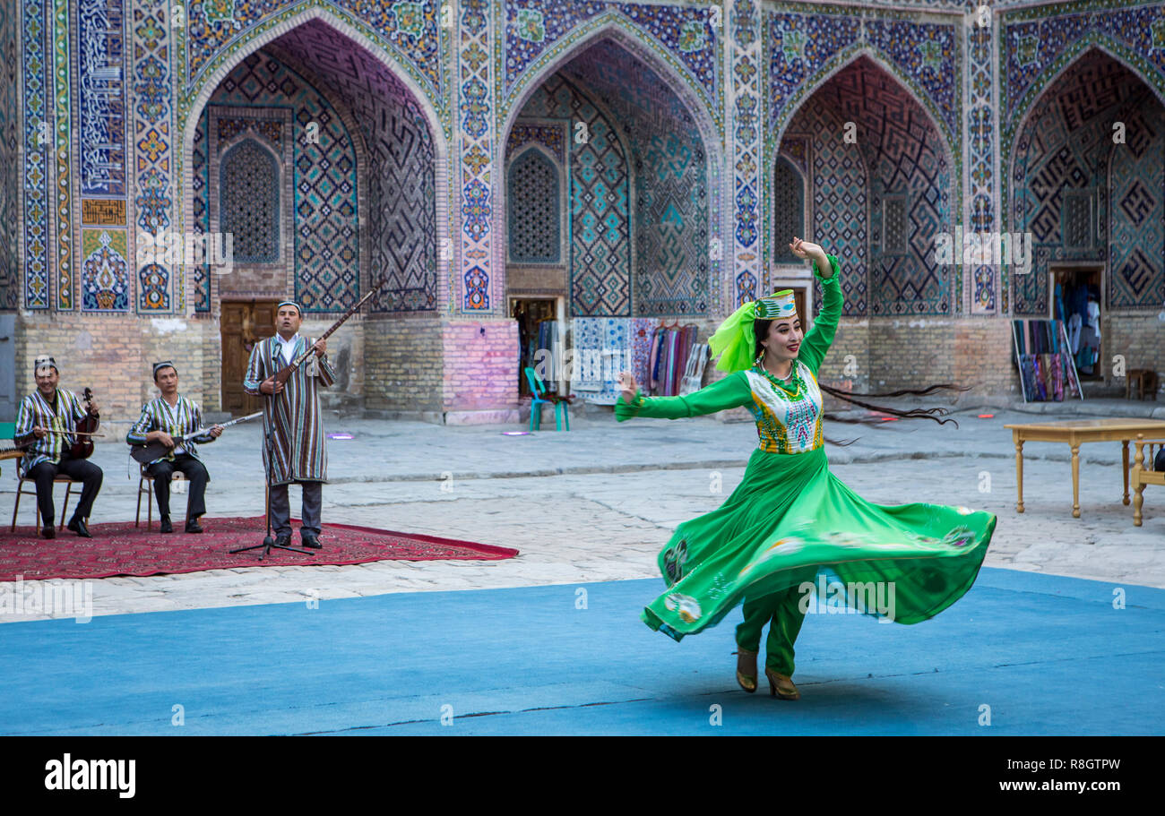 Traditional dance, folklore, spectacle, entertainment, performance, in the courtyard of Sher Dor Medressa,madrasa, Registan, Samarkand, Uzbekistan Stock Photo