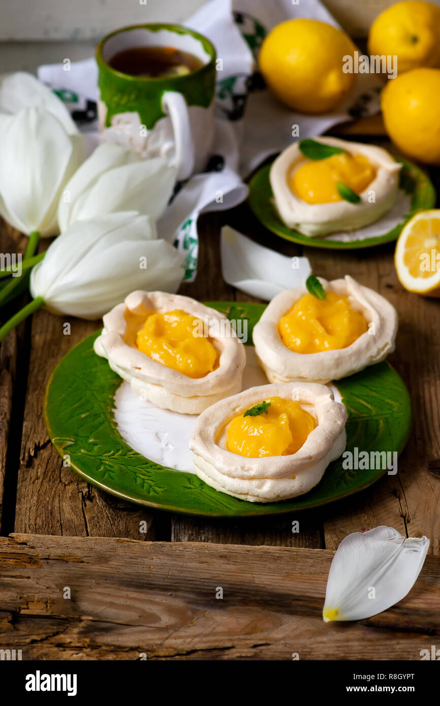 egg shaped meringue nests with lemon curd .traditional  easter pastries. selective focus Stock Photo