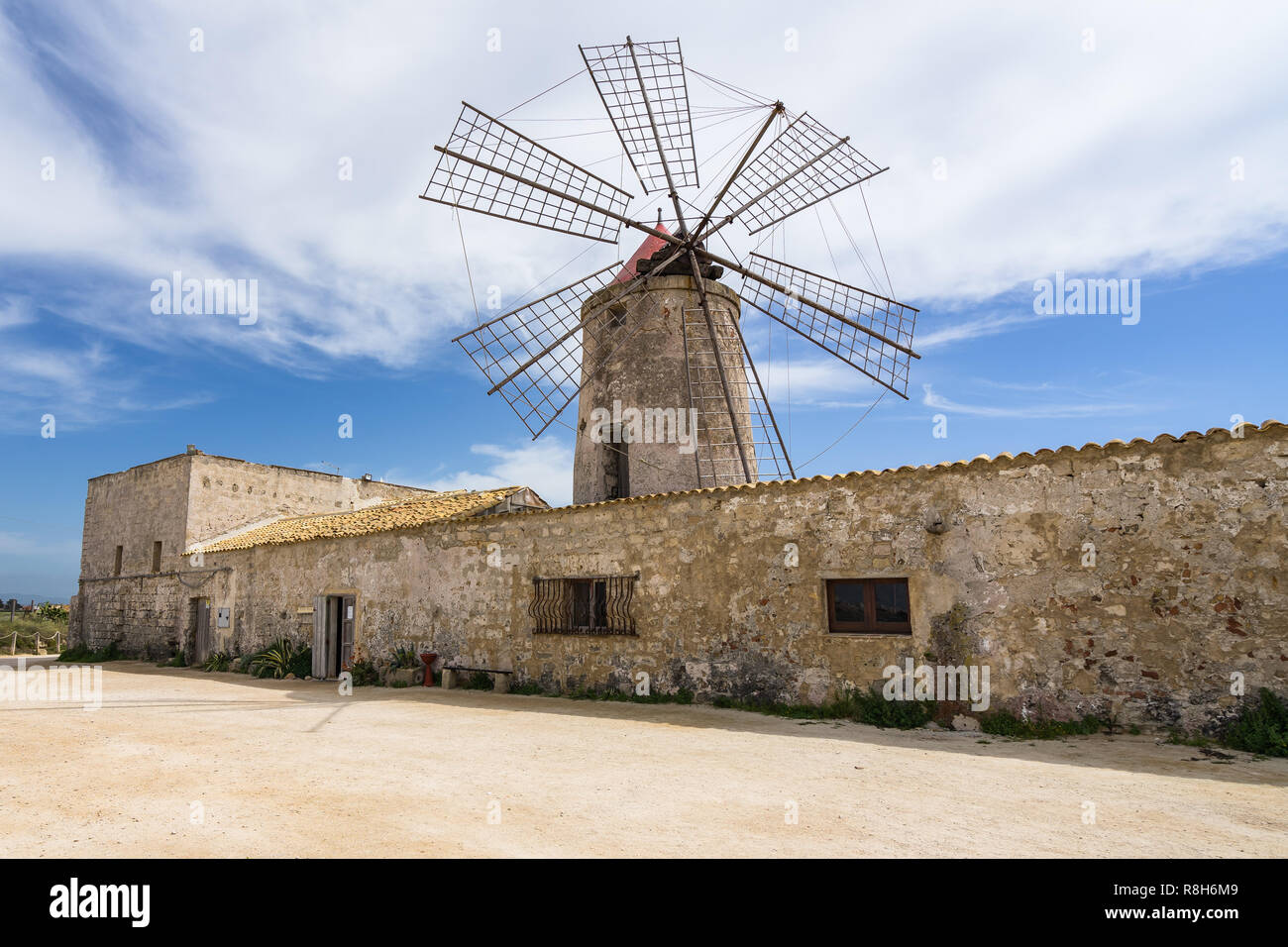 Typical old windmill now housing a salt museum (Museo del Sale) at Trapani salt flats, Sicily, Italy Stock Photo